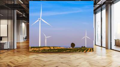 Wind turbines electric power generator on blue sky at agriculture field Wall mural