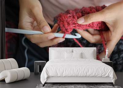 A girl showing how to crochet Wall mural