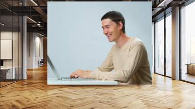 Man is using laptop for communication in chat or video chat. Social media concept. Wall mural