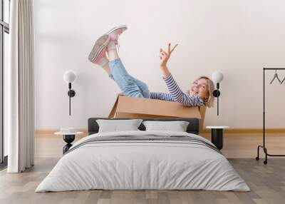 Photo of young woman sitting in cardboard box Wall mural