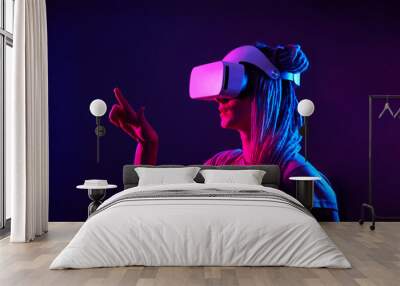 Woman is using virtual reality headset. Neon light studio portrait. Wall mural