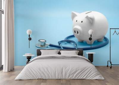 Piggy bank with stethoscope isolated on light blue background with copy space. Health care financial checkup or saving for medical insurance costs concept. Wall mural