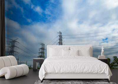 High voltage transmission towers, the sky behind bright. Wall mural