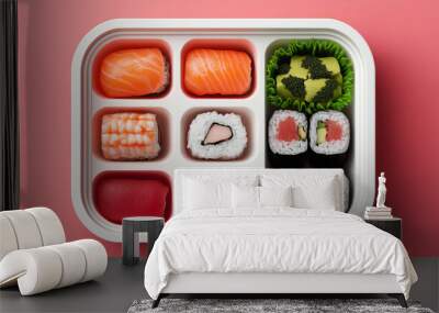 An arranged sushi platter featuring various rolls and sashimi on a vibrant pink background, showcasing culinary artistry and Japanese cuisine. Wall mural