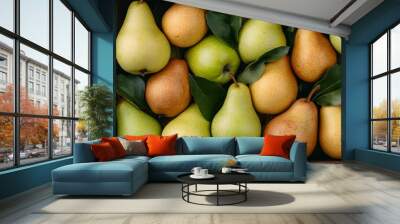 A vibrant assortment of pears in varying colors, nestled among leaves, showcasing their natural beauty and freshness. Wall mural