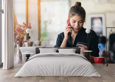 Asian woman call to bank call center for card problem Wall mural