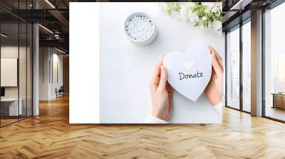 cropped view of woman holding paper heart with word DONATE on white background Wall mural