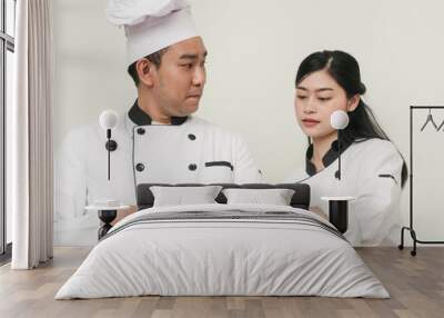 Happy Asian chef using tablet together, work lifestyle concept. Wall mural