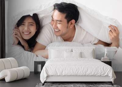 Happy Asian couple under white blanket together, lifestyle concept. Wall mural