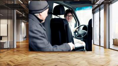 senior man sitting in paratransit van Wall mural