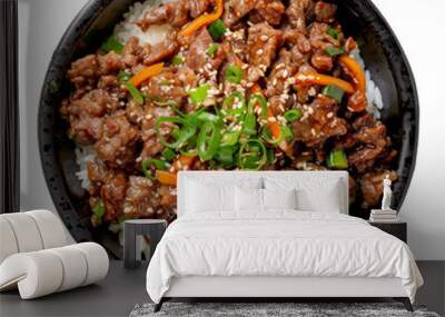 A bowl of rice topped with stir-fried meat, vegetables and sesame seeds. Wall mural