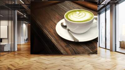 Hot green tea matcha latte on wooden table in the cafe
 Wall mural