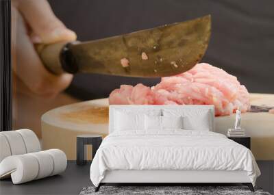 Chef chopping raw pork on wooden board for cooking Wall mural