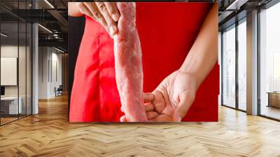 Chef hand holding raw pork prepared for cooking Wall mural