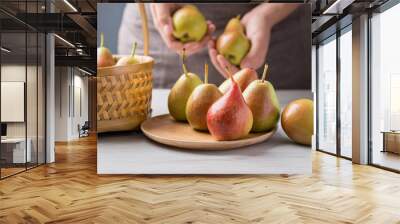 Fresh pear fruit with hand preparing for eating Wall mural