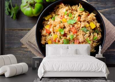 Fried rice with vegetables in a black bowl, Asian food, top view Wall mural