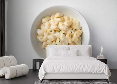 Macaroni cheese in bowl on white background, Top view Wall mural