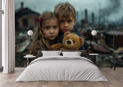 A deeply moving image featuring two young siblings embracing, holding a teddy bear amid the aftermath of a catastrophic event, capturing their unity and resilience Wall mural