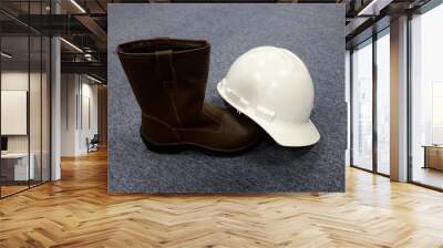 Safety helmets and safety shoes are equipment that must be used by construction workers to avoid work accidents Wall mural