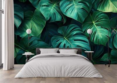 Lush green tropical leaves with intricate patterns and textures. Wall mural