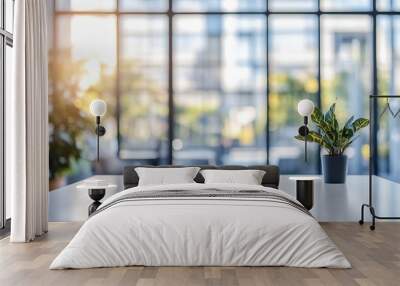 Minimalist office desk with a single plant and a blurred window background. Wall mural