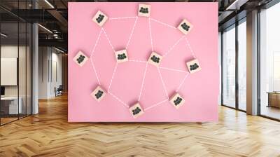 Wooden blocks connected together on pink background. teamwork concept. Wall mural