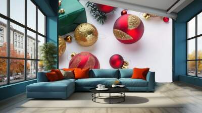 Red and gold Christmas balls, green gifts, and festive decorations on a solid white background with ample empty space. Wall mural