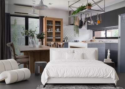 cozy pantry area with natural wood dining table and stainless hanging  shelves in modern vintage style Wall mural