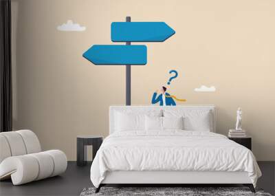 Choosing between 2 choices, make decision to the left or right, thinking in difficult situation, confusion concept, businessman thinking with question mark choose between 2 direction with copy space. Wall mural