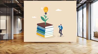 Knowledge, wisdom to create new idea, creativity or innovation from reading books, education or learning new skill to success, study or library, smart young man with book stack with light bulb plant. Wall mural