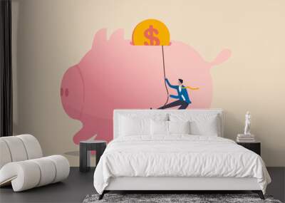 Personal finance strategy, income tax or investment target for office worker retirement concept, confidence businessman using rope to climb up pink piggy bank with golden money coin as final target. Wall mural