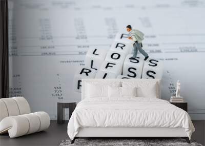 Risk, profit and loss in investment concept, miniature businessman walking on small white cube block with alphabet with crossword word mainly as Profit, Loss and Risk on financial investment reports Wall mural