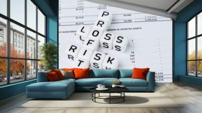 Risk, profit and loss in investment concept, small white cube block with alphabet building the crossword word mainly as Profit with the word Loss and Risk on financial investment reports Wall mural