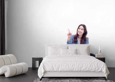 Happy young asian woman sitting on floor with legs crossed and using laptop computer isolated on white background copy space Full body young smiling happy female pointing up to copy space	 Wall mural