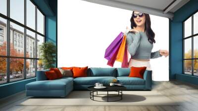 Portrait excited beautiful girl wearing sunglasses holding shopping bags and looking up to copy space Beautiful Asian young woman enjoy shopping isolated over white background Portrait cheerful girl Wall mural