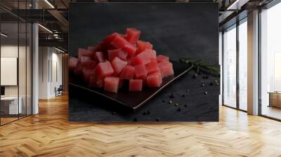 Raw fresh Tuna cube on black plate. Black wooden background. Wall mural