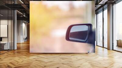 Car driving on the road. Blur Reflection in a car mirror.Rear view mirror reflection.Close up of car mirror with reflection of behind the car. Wall mural