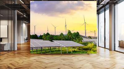 Solar cell panels and wind turbines in sunset sky for alternatively power generator source, renewable energy for future power supply and eco-friendly with environment Wall mural