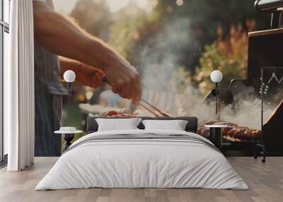 A man grilling food on a barbecue grill outdoors, with smoke rising from the grill. Wall mural