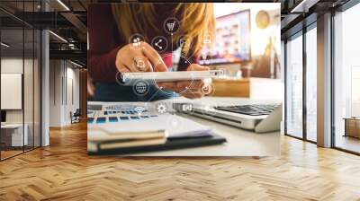  businesswoman hand working with laptop computer, tablet and smart phone in modern office with virtual icon diagram at modernoffice in morning light 
 Wall mural