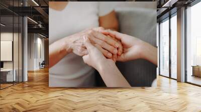 Asian female hands touching old female hand Helping hands take care of the elderly concept Wall mural