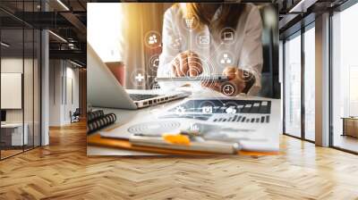 Digital marketing media in virtual screen.businesswoman hand working with mobile phone and modern compute with VR icon diagram at office in morning light  Wall mural