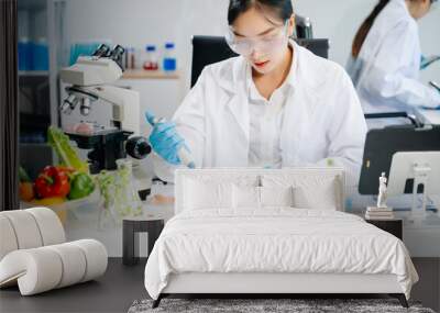 Food scientists in lab coats, testing samples, and analyzing food safety and quality in a laboratory Wall mural