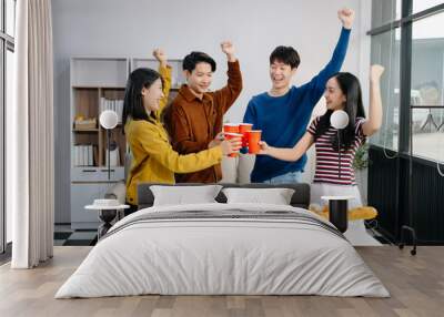 Group of Young Asian friend having, enjoy evening party together at home. Attractive young man and woman having fun, eating food, celebrate at home. Wall mural