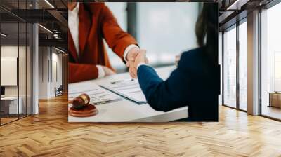 Judge and client shaking hands and lawyers discussing contract papers  after adviced in background at courtroom, lawyer service concept. Wall mural