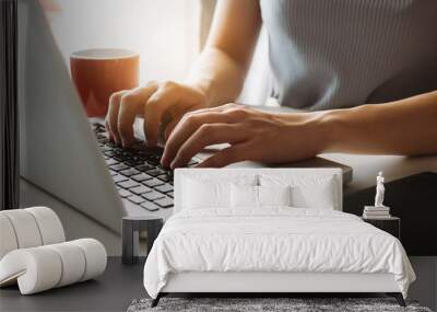 Social media and Marketing virtual icons screen of businesswoman typing keyboard with laptop computer at office at morning light Wall mural