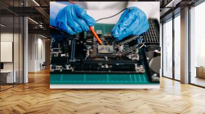 The technician is putting the CPU on the socket of the computer motherboard. electronic engineering electronic repair, electronics measuring and testing, repair.. Wall mural