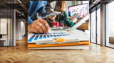 Working team meeting concept, businessman using smart phone and laptop and digital tablet computer in modern office with virtual interface icons network diagram at modern office in morning light Wall mural