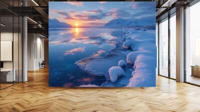 A serene winter landscape featuring a sunset over icy waters, surrounded by snow-covered mountains and a colorful sky. Wall mural