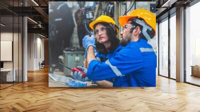 Engineers team mechanic using computer controller Robotic arm for welding steel in steel factory workshop. Industry robot programming software for automated manufacturing technology Wall mural